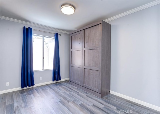 23113 Cherry Ave Unit 15, Lake Forest, CA 92630 - unfurnished bedroom featuring crown molding and wood finished floors