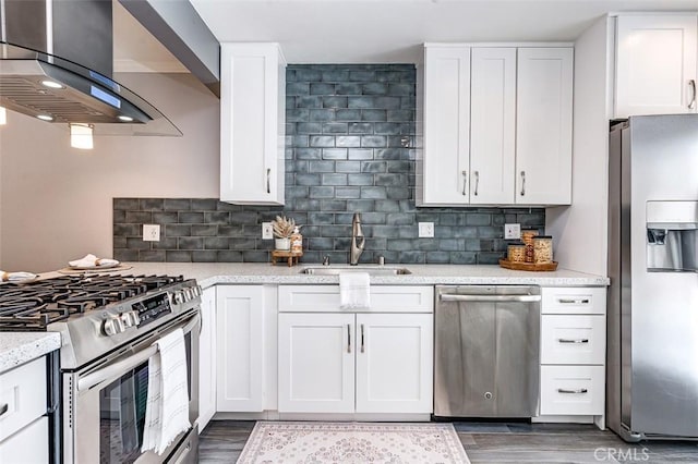 23113 Cherry Ave Unit 15, Lake Forest, CA 92630 - kitchen featuring stainless steel appliances, ventilation hood, tasteful backsplash, wood finished floors, and white cabinetry