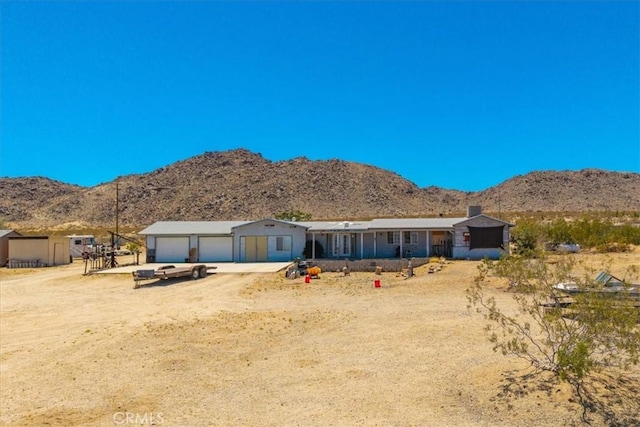 5177 Avenida Del Sol, Joshua Tree, CA 92252 - view of front of home with a mountain view, driveway, and an attached garage