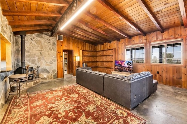 5177 Avenida Del Sol, Joshua Tree, CA 92252 - living room featuring wood walls, a wood stove, concrete floors, and wooden ceiling