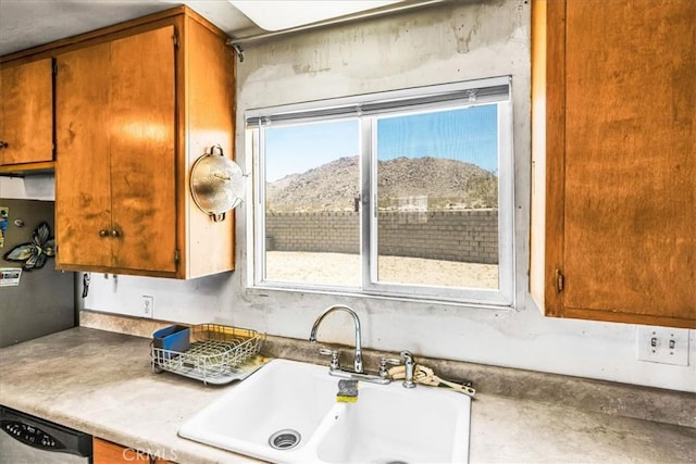 5177 Avenida Del Sol, Joshua Tree, CA 92252 - kitchen featuring plenty of natural light, stainless steel dishwasher, a mountain view, and brown cabinetry