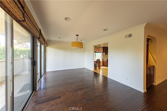 6242 Riviera Cir, Long Beach, CA 90815 - empty room featuring wood finished floors, ornamental molding, and arched walkways