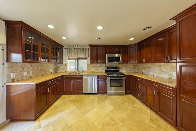 6242 Riviera Cir, Long Beach, CA 90815 - kitchen featuring appliances with stainless steel finishes, glass insert cabinets, decorative backsplash, light stone counters, and recessed lighting
