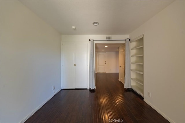 6242 Riviera Cir, Long Beach, CA 90815 - spare room featuring dark wood-type flooring, built in features, a smoke detector, and recessed lighting