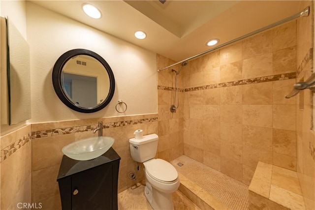 6242 Riviera Cir, Long Beach, CA 90815 - full bathroom with tile walls, recessed lighting, vanity, tiled shower, and a wainscoted wall