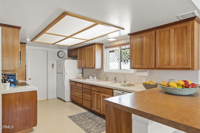 4907 Island View St, Oxnard, CA 93035 - kitchen with white appliances, brown cabinets, and light countertops