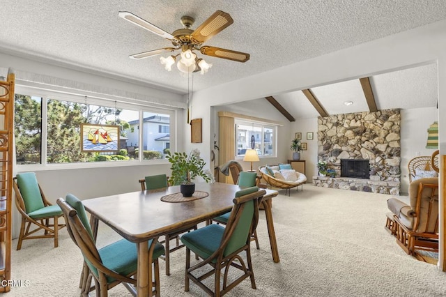 4907 Island View St, Oxnard, CA 93035 - dining space featuring light colored carpet, a textured ceiling, a fireplace, and a ceiling fan