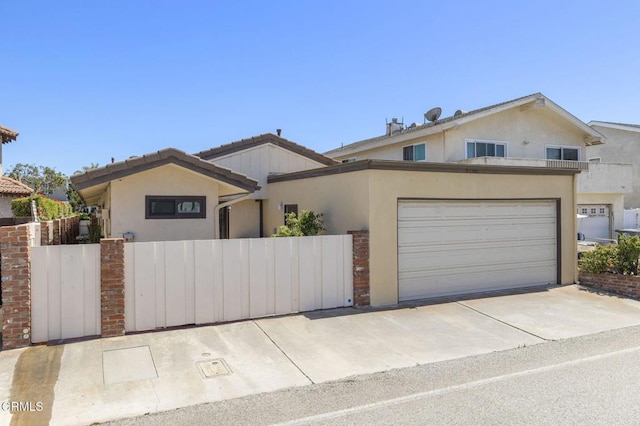 4907 Island View St, Oxnard, CA 93035 - view of front facade with stucco siding, a gate, concrete driveway, and a garage