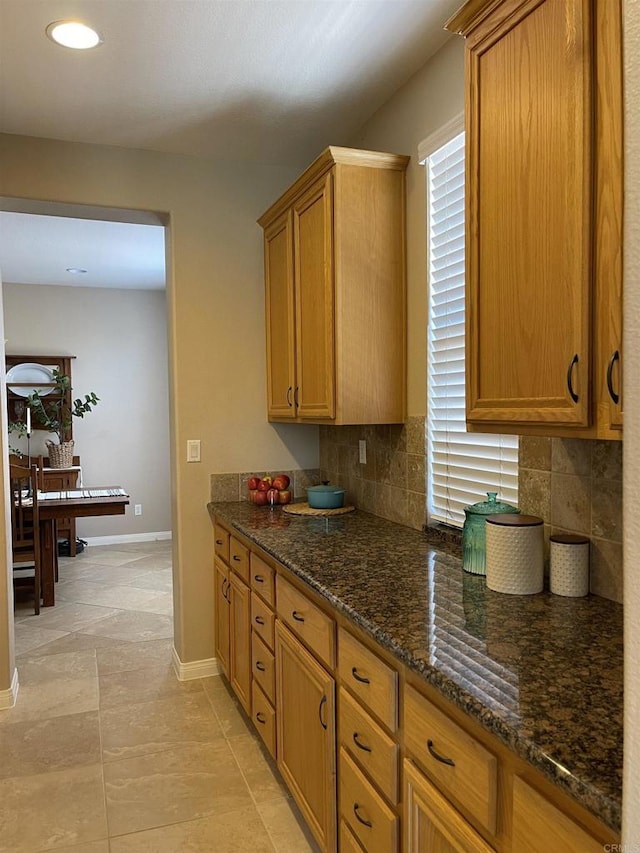 595 S Hidden Trails Rd, Escondido, CA 92027 - kitchen featuring decorative backsplash, dark stone countertops, recessed lighting, and brown cabinetry