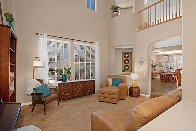 595 S Hidden Trails Rd, Escondido, CA 92027 - living area with carpet, a towering ceiling, a chandelier, and arched walkways