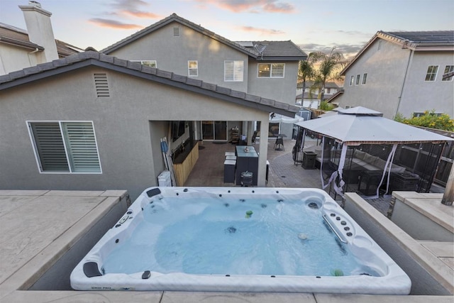 1209 Morgan Hill Dr, Chula Vista, CA 91913 - back of property with a hot tub, a gazebo, a patio area, and stucco siding