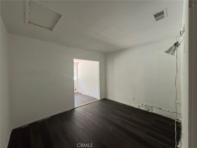 28869 Paradise Rd, Castaic, CA 91384 - spare room featuring dark wood-style floors and attic access