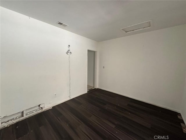 28869 Paradise Rd, Castaic, CA 91384 - spare room with dark wood finished floors and attic access
