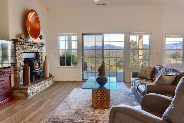 31008 Longview Ln E, Coarsegold, CA 93614 - living room featuring wood finished floors, a wood stove, and a mountain view