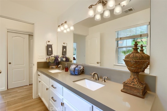 31008 Longview Ln E, Coarsegold, CA 93614 - full bath with double vanity, wood finished floors, and a chandelier