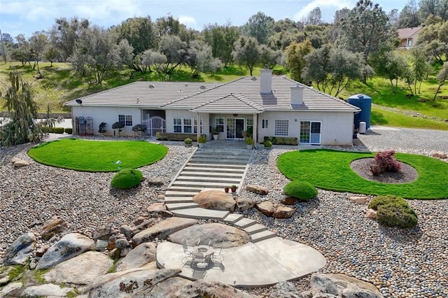 31008 Longview Ln E, Coarsegold, CA 93614 - back of house featuring a chimney, a tiled roof, a lawn, and stucco siding
