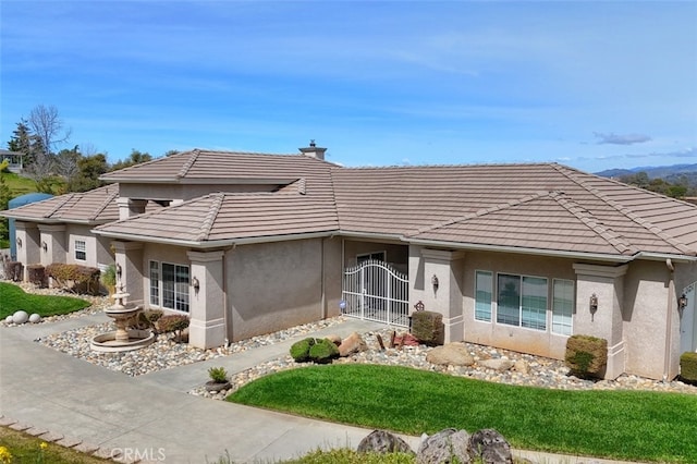 31008 Longview Ln E, Coarsegold, CA 93614 - rear view of house featuring stucco siding, a tiled roof, and a lawn