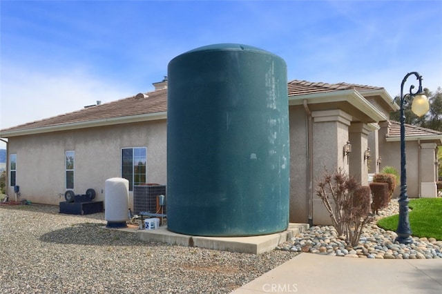 31008 Longview Ln E, Coarsegold, CA 93614 - view of side of home featuring a tiled roof, stucco siding, and a chimney