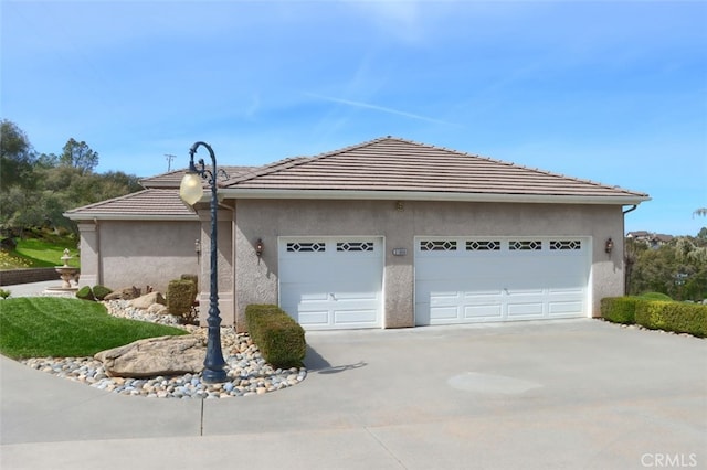 31008 Longview Ln E, Coarsegold, CA 93614 - view of property exterior with a garage, driveway, stucco siding, and a tiled roof
