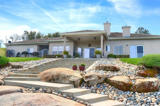 31008 Longview Ln E, Coarsegold, CA 93614 - view of front of property with a chimney, stucco siding, and stairs