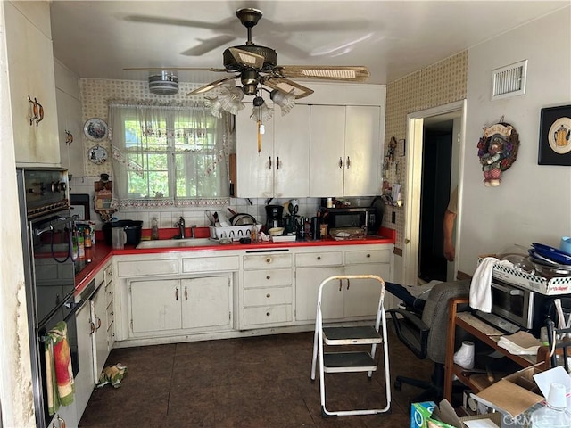 1021 E Gaillard St, Azusa, CA 91702 - kitchen featuring a ceiling fan, white cabinets, decorative backsplash, and dark tile patterned floors