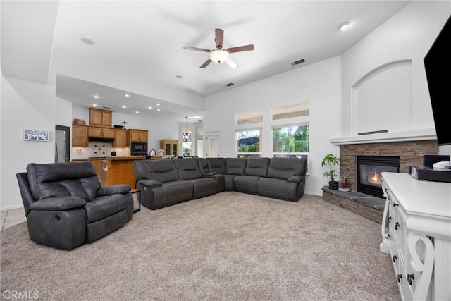 403 Stone Cross Dr, Bakersfield, CA 93312 - living room featuring a ceiling fan, light colored carpet, a stone fireplace, and recessed lighting