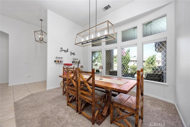 403 Stone Cross Dr, Bakersfield, CA 93312 - tiled dining room with a high ceiling, a chandelier, and carpet