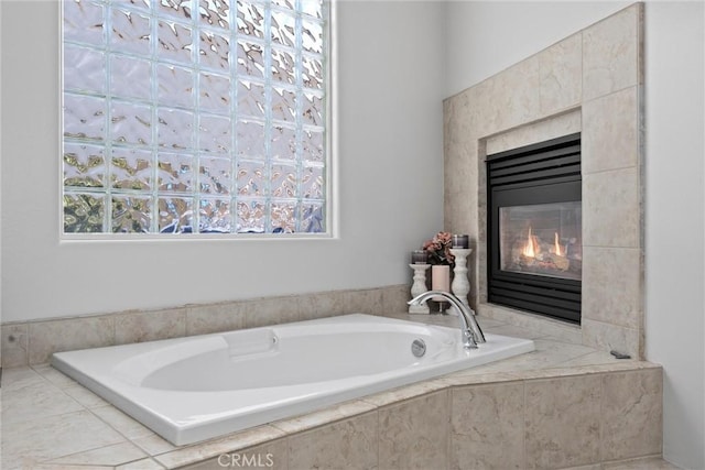 403 Stone Cross Dr, Bakersfield, CA 93312 - full bathroom featuring a tiled fireplace, a garden tub, and plenty of natural light