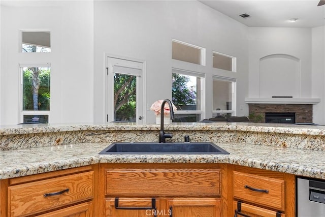 403 Stone Cross Dr, Bakersfield, CA 93312 - kitchen featuring healthy amount of natural light, light stone counters, brown cabinets, and open floor plan