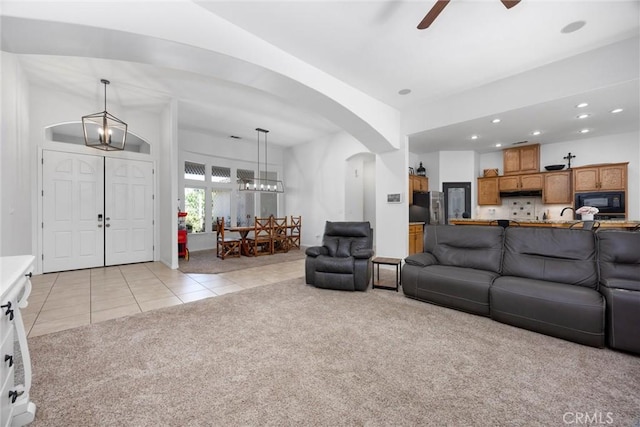 403 Stone Cross Dr, Bakersfield, CA 93312 - living room featuring light carpet, light tile patterned floors, arched walkways, ceiling fan, and recessed lighting