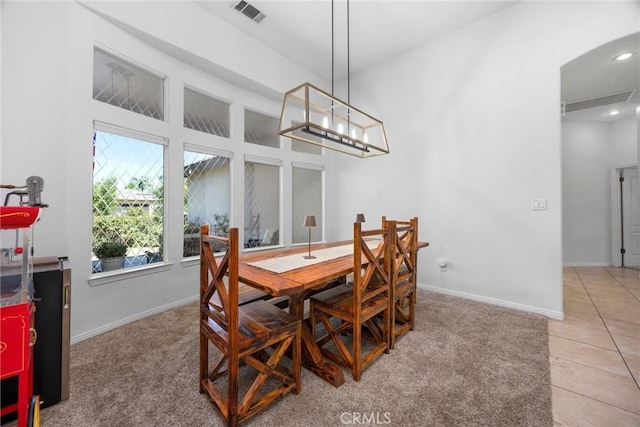 403 Stone Cross Dr, Bakersfield, CA 93312 - dining space featuring a towering ceiling, light tile patterned flooring, and arched walkways