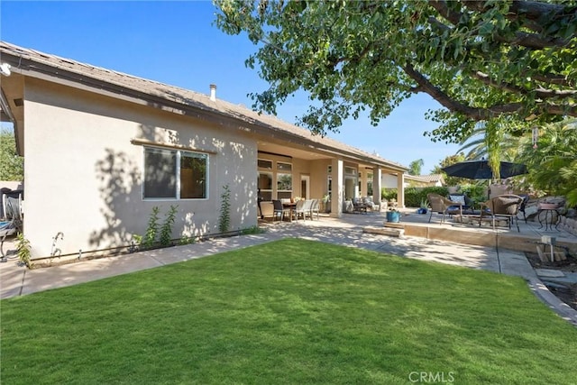 403 Stone Cross Dr, Bakersfield, CA 93312 - rear view of property featuring stucco siding, a lawn, and a patio