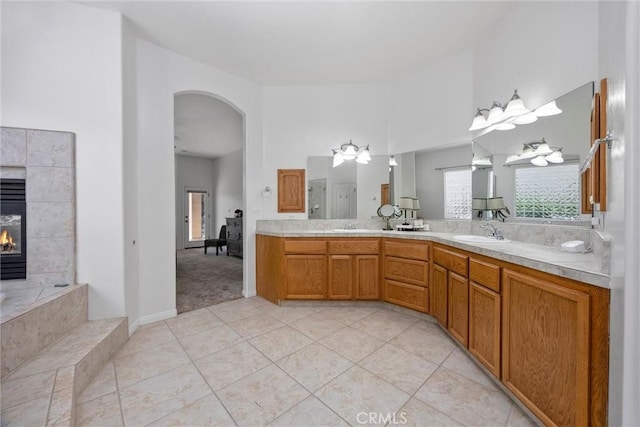 403 Stone Cross Dr, Bakersfield, CA 93312 - full bathroom with tile patterned flooring, double vanity, a fireplace, and a high ceiling