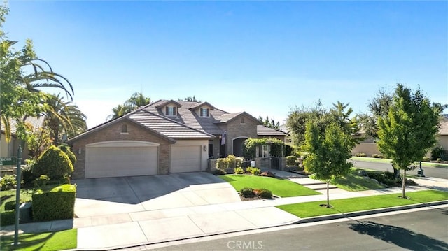 403 Stone Cross Dr, Bakersfield, CA 93312 - traditional home with an attached garage, driveway, stone siding, a tile roof, and a front lawn
