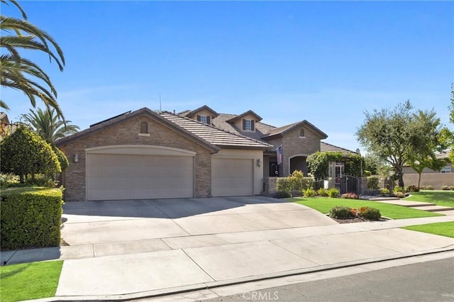 403 Stone Cross Dr, Bakersfield, CA 93312 - traditional-style home featuring a garage, stone siding, a front lawn, driveway, and a tiled roof