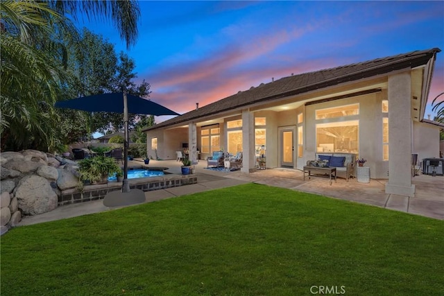 403 Stone Cross Dr, Bakersfield, CA 93312 - back of property at dusk featuring a patio area, a yard, an outdoor pool, stucco siding, and outdoor lounge area