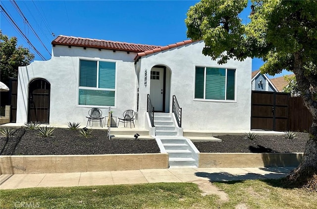 2209 W Glendon Way, Alhambra, CA 91803 - mediterranean / spanish-style home featuring stucco siding, a tiled roof, and a gate