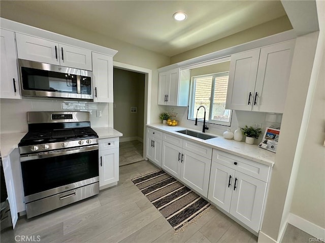 2209 W Glendon Way, Alhambra, CA 91803 - kitchen with stainless steel appliances, backsplash, white cabinetry, recessed lighting, and light wood-style floors
