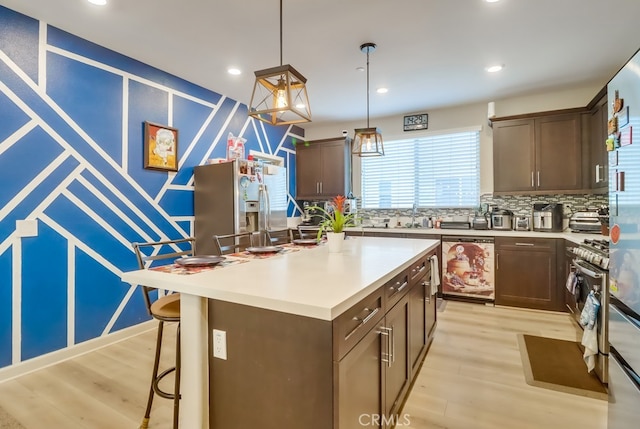 1905 Soho Ln Unit 2, Chula Vista, CA 91915 - kitchen featuring stainless steel fridge with ice dispenser, light wood-style flooring, decorative backsplash, dark brown cabinetry, and light countertops