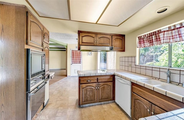 1023 Don Pablo Dr, Arcadia, CA 91006 - kitchen featuring dishwasher, oven, built in microwave, under cabinet range hood, and brown cabinetry