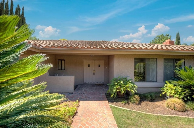 1023 Don Pablo Dr, Arcadia, CA 91006 - doorway to property with stucco siding, a tile roof, and a chimney