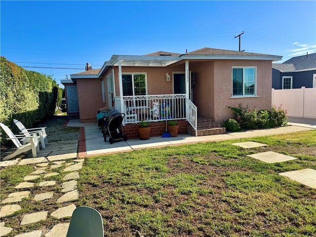 1203 W 134th Pl, Compton, CA 90222 - view of front facade with stucco siding, covered porch, a patio, and roof with shingles