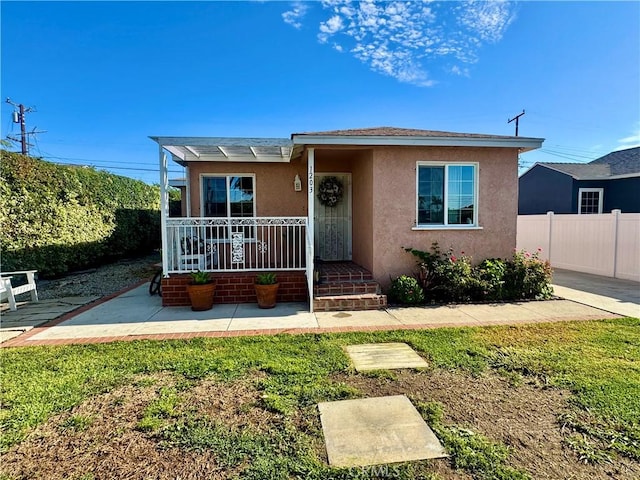 1203 W 134th Pl, Compton, CA 90222 - view of front of home featuring stucco siding and covered porch