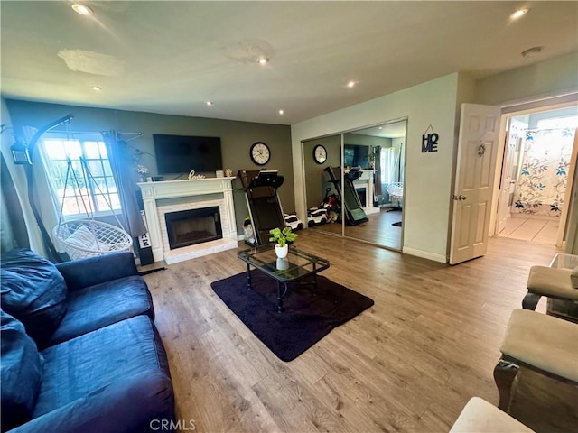 1203 W 134th Pl, Compton, CA 90222 - living area with wood finished floors, a fireplace with raised hearth, and recessed lighting