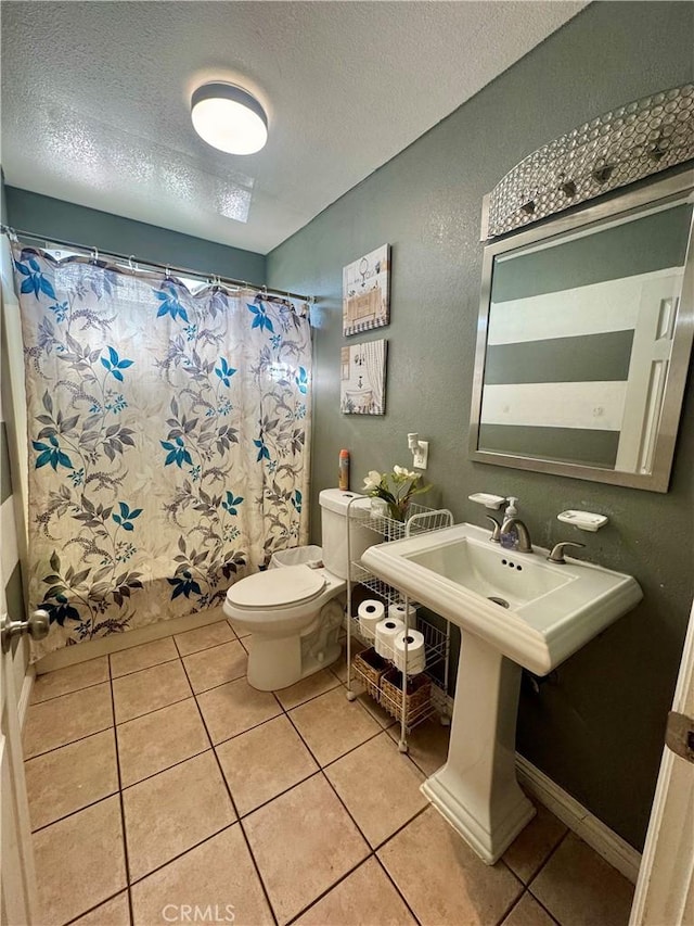1203 W 134th Pl, Compton, CA 90222 - bathroom with a textured wall, a textured ceiling, tile patterned flooring, and shower / bath combination with curtain