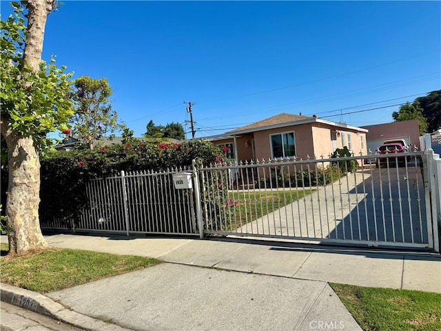 1203 W 134th Pl, Compton, CA 90222 - bungalow-style home featuring stucco siding and a gate