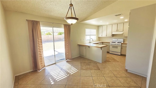 37432 Whitehall Ln, Palmdale, CA 93550 - kitchen featuring gas range gas stove, a peninsula, under cabinet range hood, light countertops, and light tile patterned floors