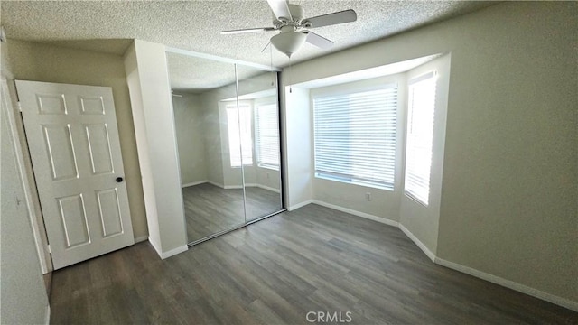 37432 Whitehall Ln, Palmdale, CA 93550 - unfurnished bedroom with multiple windows, wood finished floors, a closet, a textured ceiling, and a ceiling fan