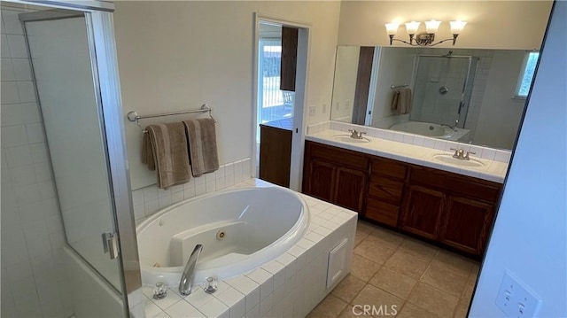 5335 Play Doe Ln, Paso Robles, CA 93446 - bathroom featuring a tub with jets, a stall shower, double vanity, a chandelier, and tile patterned flooring