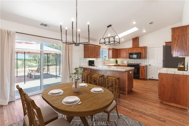5335 Play Doe Ln, Paso Robles, CA 93446 - dining space with lofted ceiling, light wood-type flooring, and recessed lighting